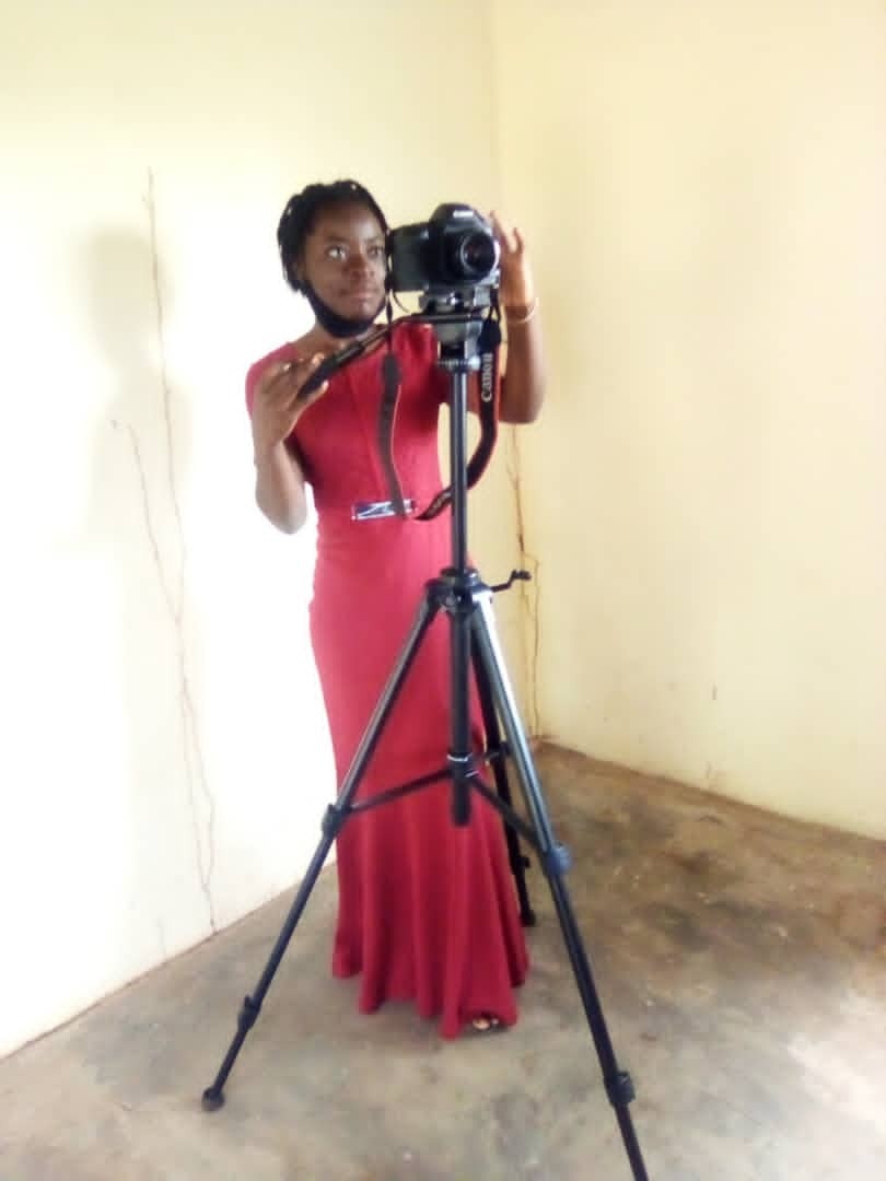 Youth demonstrating how to operate the procured camera and tripod stand Youth demonstrating how to operate the procured camera and tripod stand