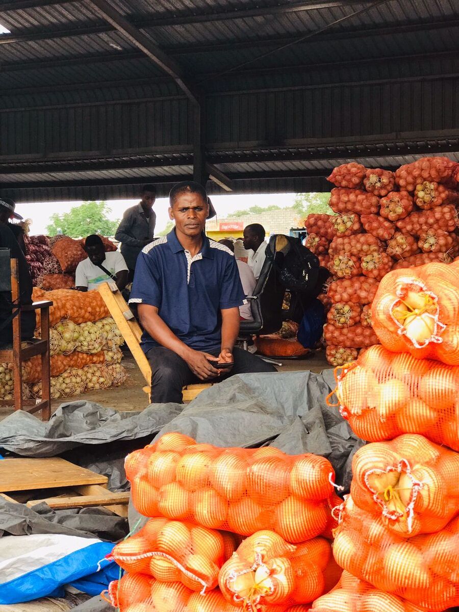 Best Siame seated next to his merchandise in Soweto market, Lusaka province. Best Siame seated next to his merchandise in Soweto market, Lusaka province.