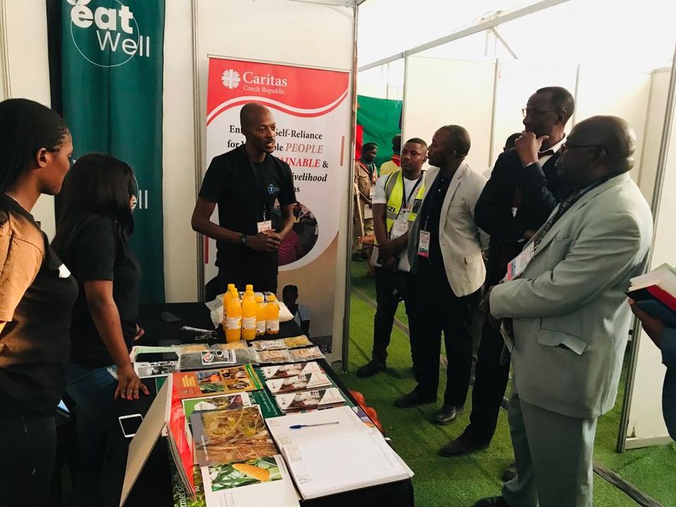 Our staff in black t-shirts giving information to the minister in grey suit Our staff in black t-shirts giving information to the minister in grey suit